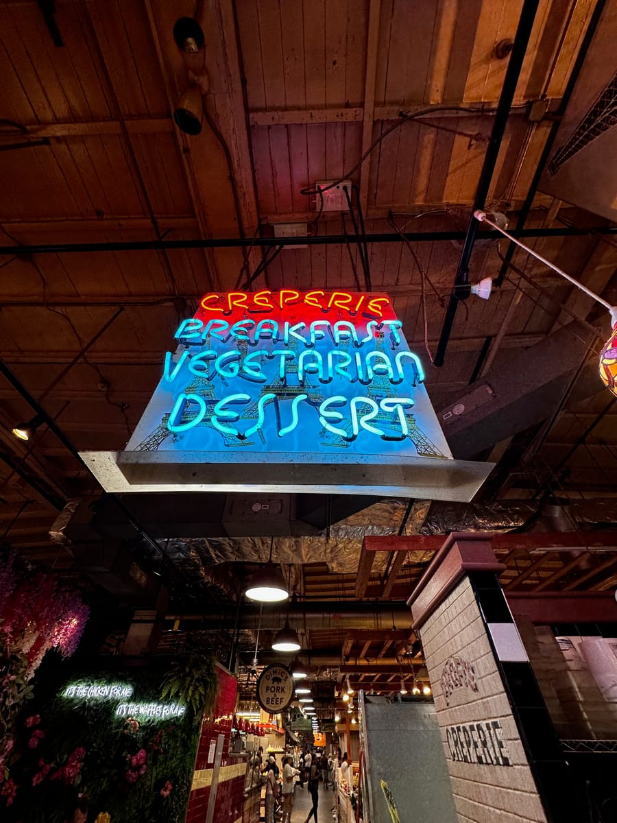 A neon sign glowing under a timber ceiling