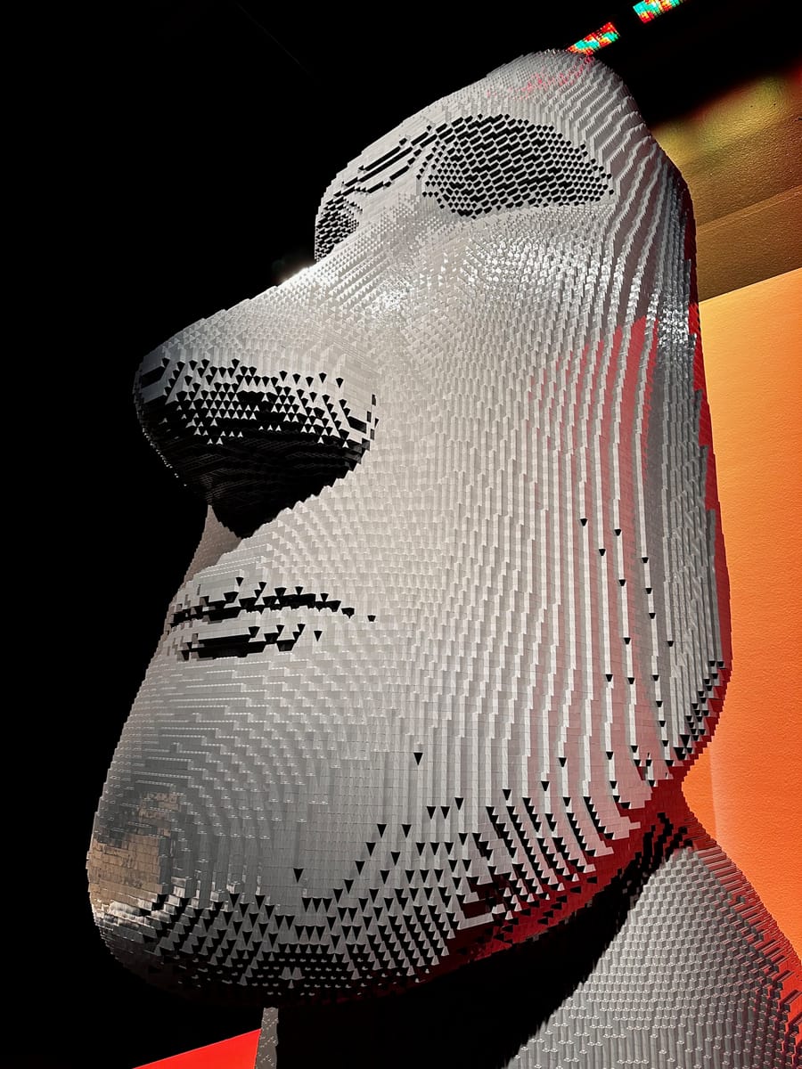 A large head sculpture built from white bricks
