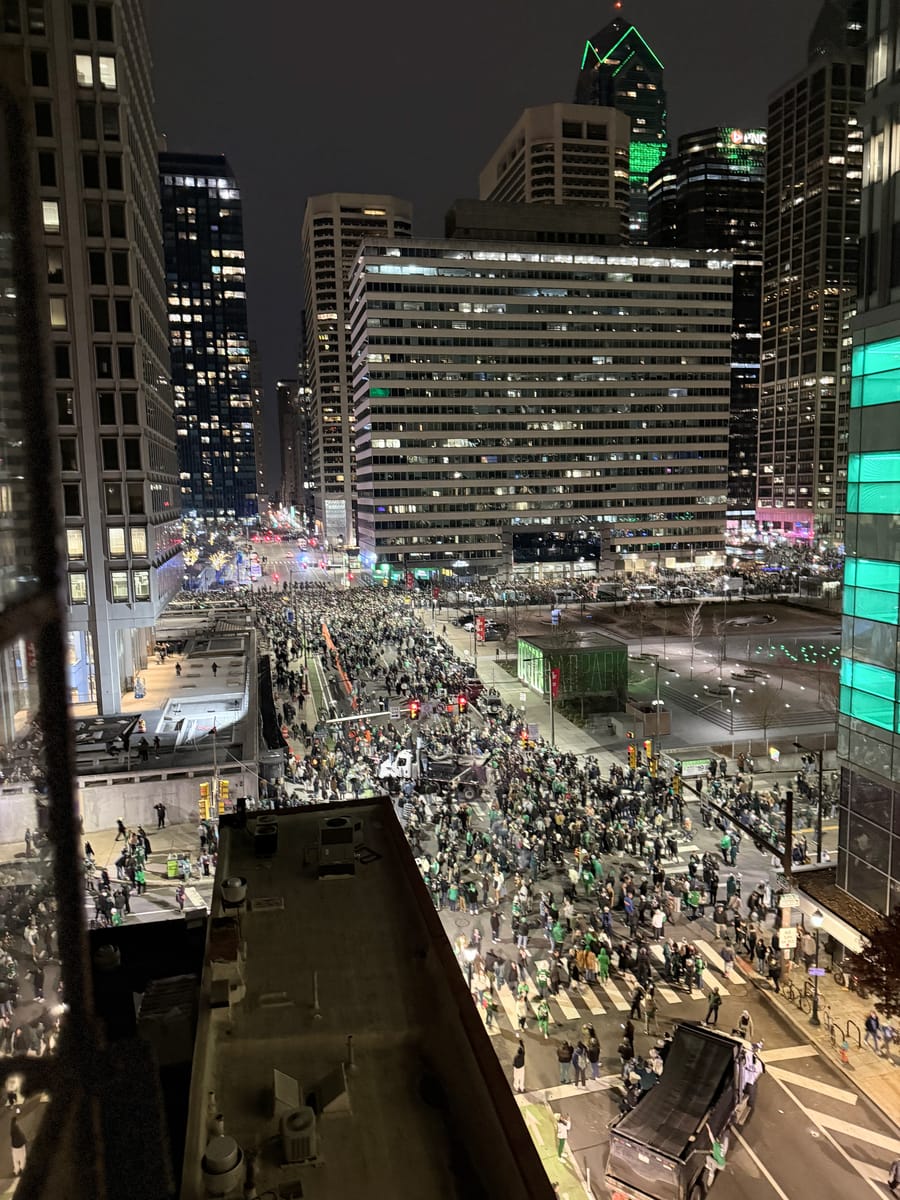 A crowd filling the street at night, seen from above