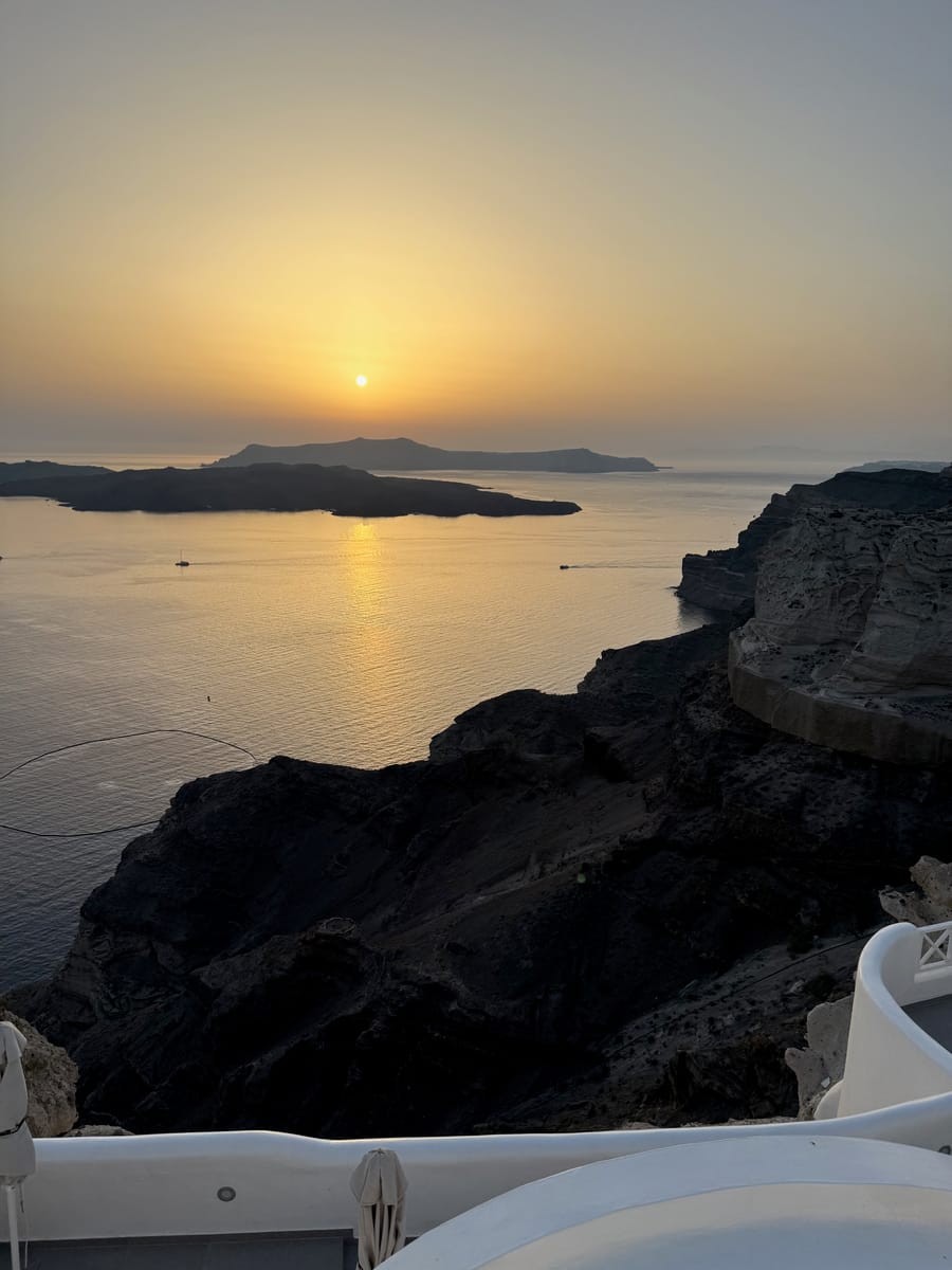 Sunset over the caldera from a clifftop terrace