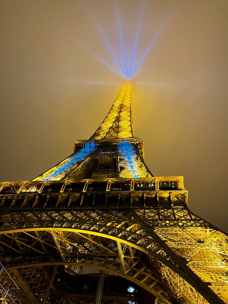 The Eiffel Tower lit at night, seen from below